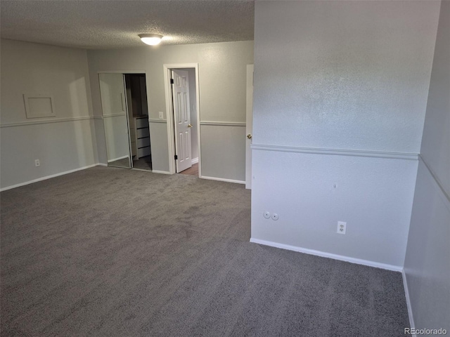 16835 E Harvard Pl, Aurora, CO 80013 - spare room with dark carpet, a textured ceiling, and baseboards