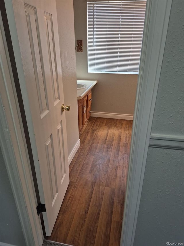 16835 E Harvard Pl, Aurora, CO 80013 - bathroom featuring wood finished floors, vanity, baseboards, and a textured wall
