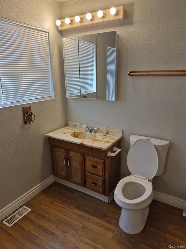 16835 E Harvard Pl, Aurora, CO 80013 - bathroom with vanity, toilet, and wood finished floors