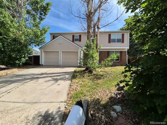 16835 E Harvard Pl, Aurora, CO 80013 - traditional-style house with a garage, driveway, and brick siding