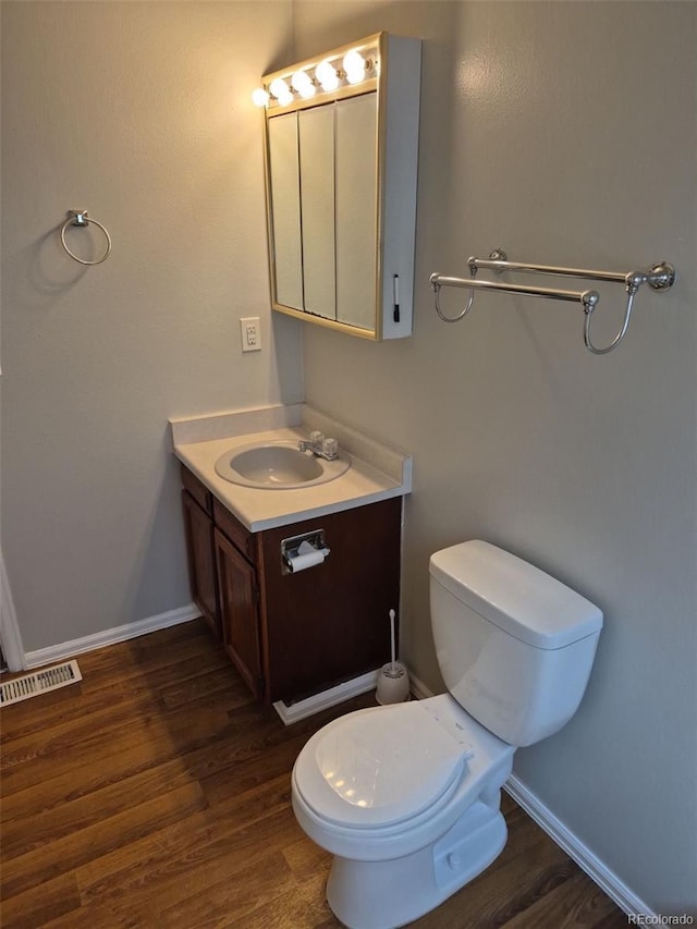 16835 E Harvard Pl, Aurora, CO 80013 - bathroom featuring vanity, wood finished floors, toilet, and baseboards