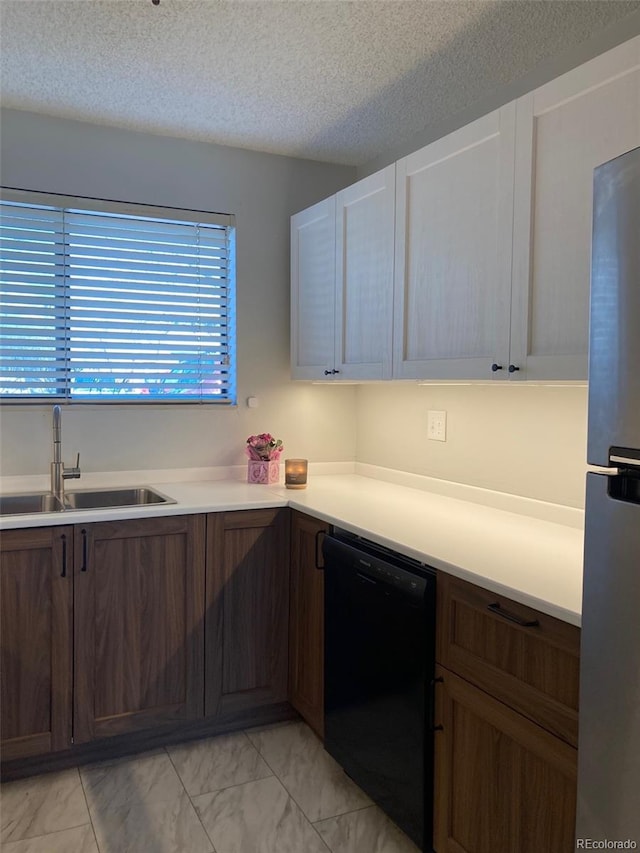 kitchen with sink, stainless steel fridge, a textured ceiling, black dishwasher, and white cabinetry