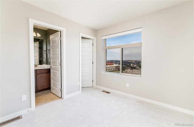 10154 Belvedere Loop, Lone Tree, CO 80124 - unfurnished bedroom with light carpet, baseboards, a sink, and ensuite bath