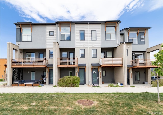 10154 Belvedere Loop, Lone Tree, CO 80124 - back of house with stucco siding, outdoor lounge area, and a lawn
