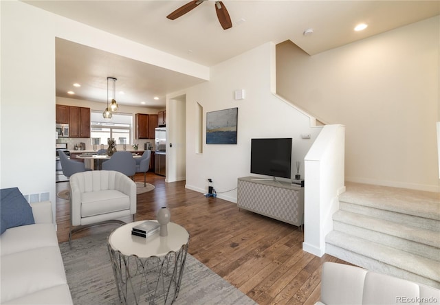 10154 Belvedere Loop, Lone Tree, CO 80124 - living area with wood finished floors, ceiling fan, stairs, and recessed lighting