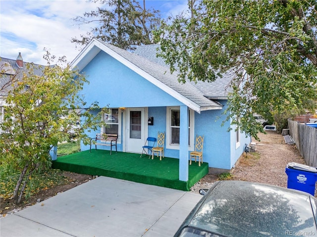 bungalow-style home with a patio area and a front lawn