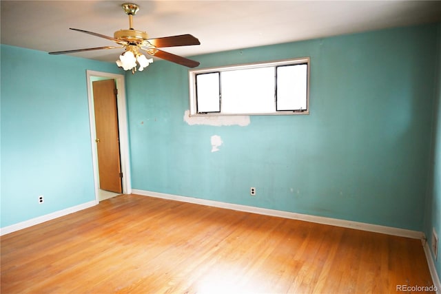 empty room featuring hardwood / wood-style floors and ceiling fan