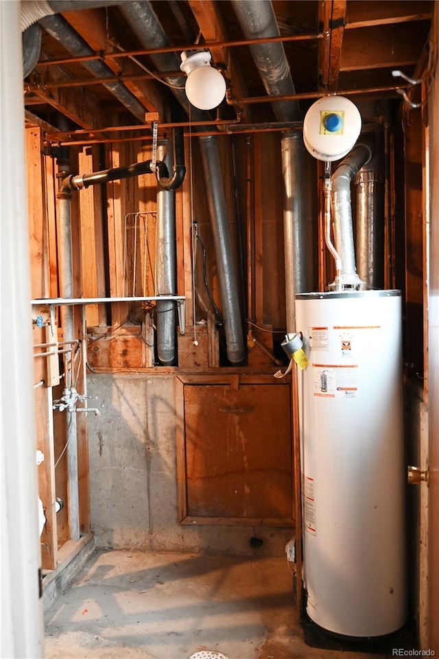 utility room featuring water heater