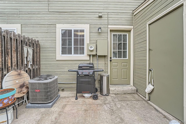 view of patio featuring central AC, a grill, and fence