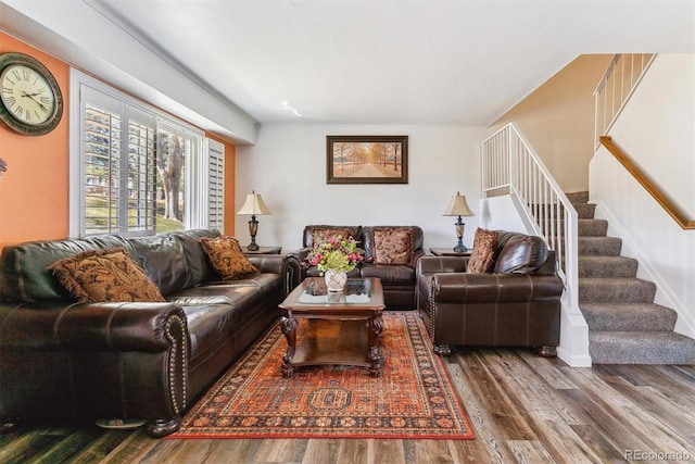 living area with stairway and wood finished floors