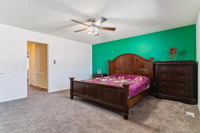 bedroom with carpet floors, a textured ceiling, and a ceiling fan