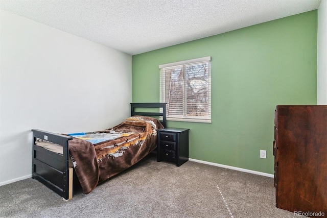 bedroom with a textured ceiling, baseboards, and carpet floors