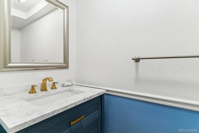 bathroom featuring a wainscoted wall and vanity