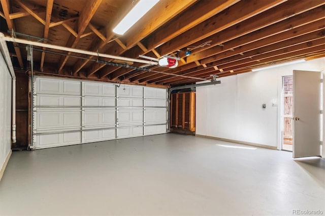 garage with a garage door opener and baseboards