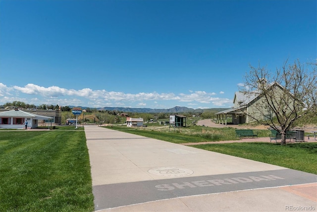 surrounding community featuring a mountain view and a yard