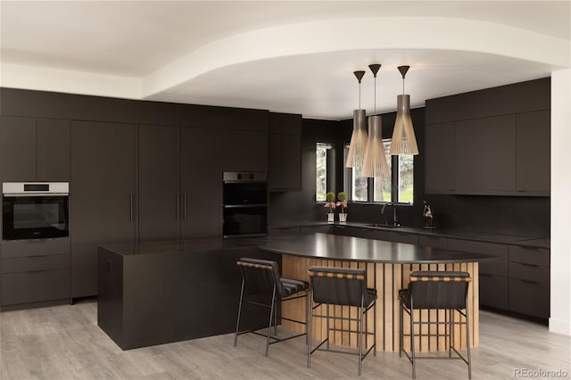 4935 E Preserve Ln, Greenwood Village, CO 80121 - kitchen with modern cabinets, dark countertops, double oven, a breakfast bar area, and hanging light fixtures