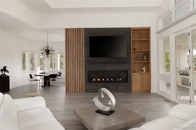 4935 E Preserve Ln, Greenwood Village, CO 80121 - living area featuring wood finished floors, a chandelier, and a large fireplace