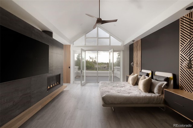 4935 E Preserve Ln, Greenwood Village, CO 80121 - bedroom with access to outside, vaulted ceiling, a tiled fireplace, wood finished floors, and ceiling fan