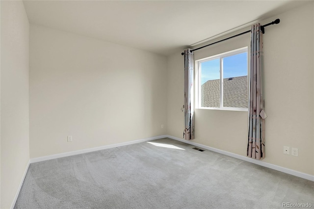 spare room with carpet floors and baseboards