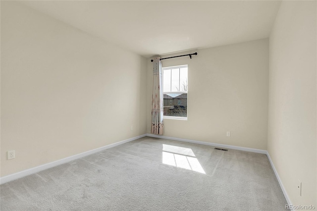 carpeted empty room with baseboards and visible vents