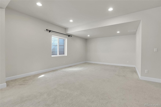 unfurnished room featuring baseboards, recessed lighting, and light colored carpet