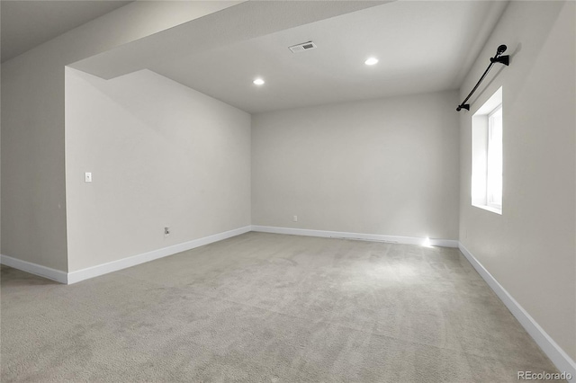 empty room with recessed lighting, baseboards, and light colored carpet