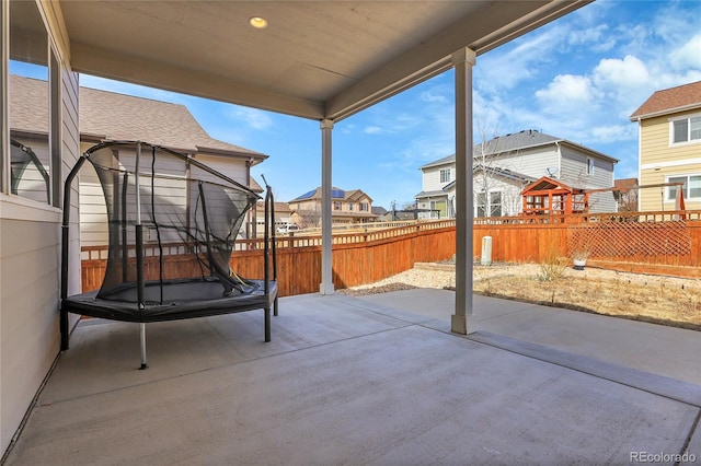 view of patio / terrace featuring a fenced backyard and a residential view
