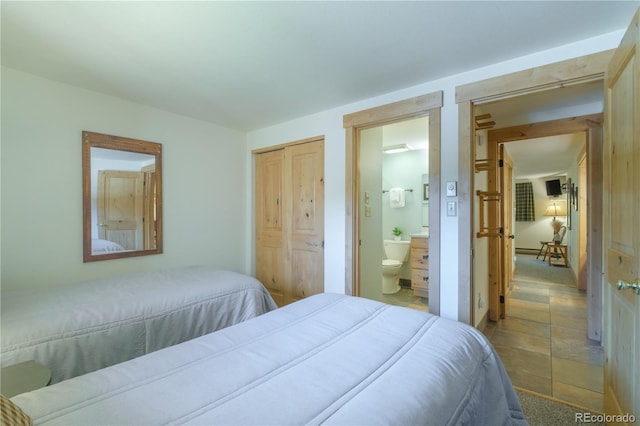 bedroom featuring connected bathroom and a closet