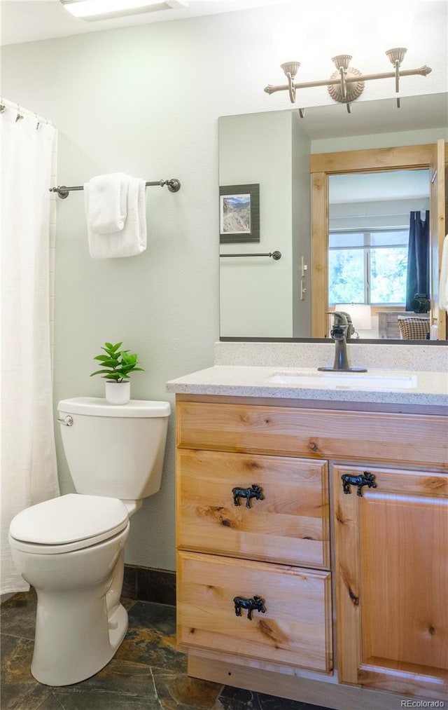 bathroom featuring vanity and toilet