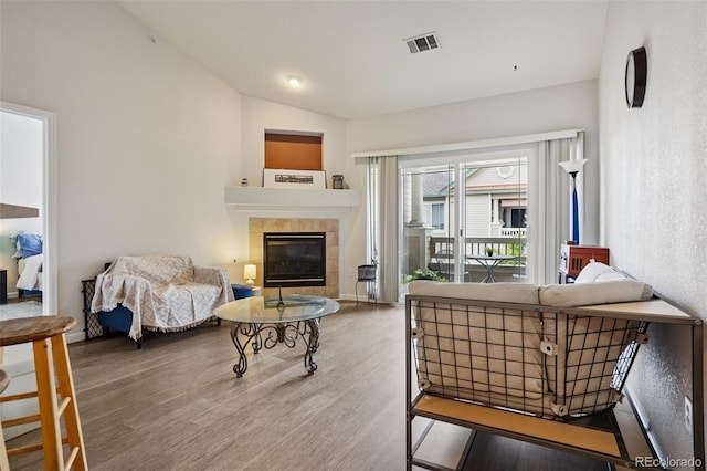 9692 W Coco Cir Unit 304, Littleton, CO 80128 - living room with wood finished floors, vaulted ceiling, and a fireplace