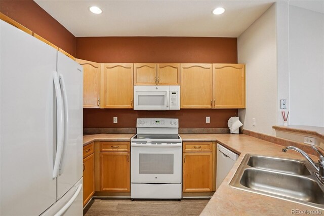 9692 W Coco Cir Unit 304, Littleton, CO 80128 - kitchen featuring white appliances, a sink, light countertops, recessed lighting, and light brown cabinetry