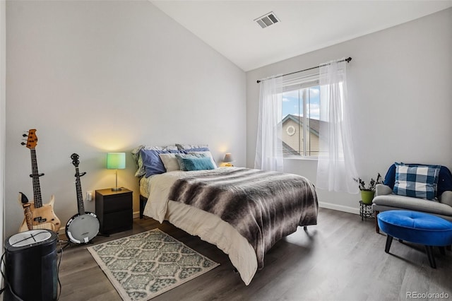 9692 W Coco Cir Unit 304, Littleton, CO 80128 - bedroom featuring vaulted ceiling, wood finished floors, and baseboards