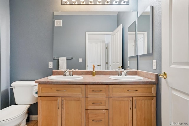9692 W Coco Cir Unit 304, Littleton, CO 80128 - bathroom with double vanity, toilet, and a textured wall