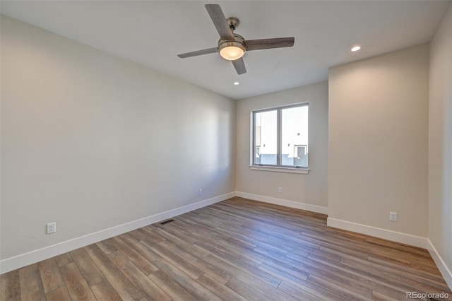 spare room with ceiling fan and light hardwood / wood-style flooring