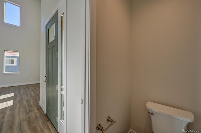 bathroom featuring wood-type flooring and toilet