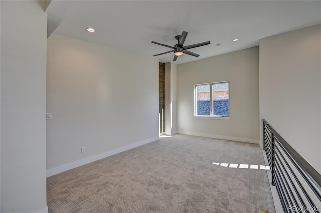 carpeted empty room featuring ceiling fan