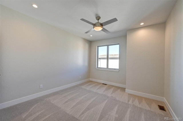 empty room with light carpet and ceiling fan