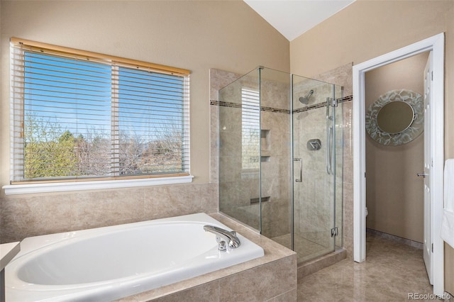 full bath with a healthy amount of sunlight, vaulted ceiling, a stall shower, and a bath