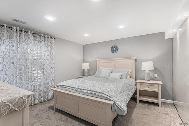 bedroom with recessed lighting, baseboards, light colored carpet, and visible vents