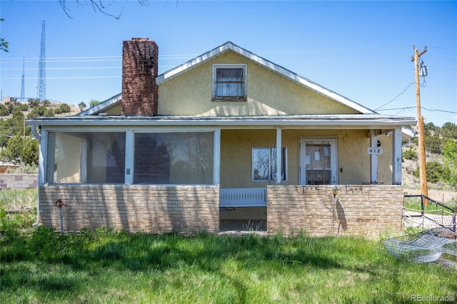 612 Pennsylvania Ave, Walsenburg, CO 81089 - view of front of house with stucco siding and a chimney