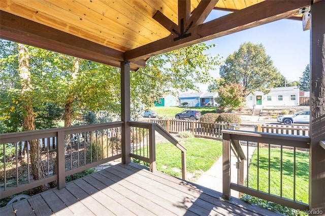 wooden terrace with a lawn, a fenced backyard, and a residential view