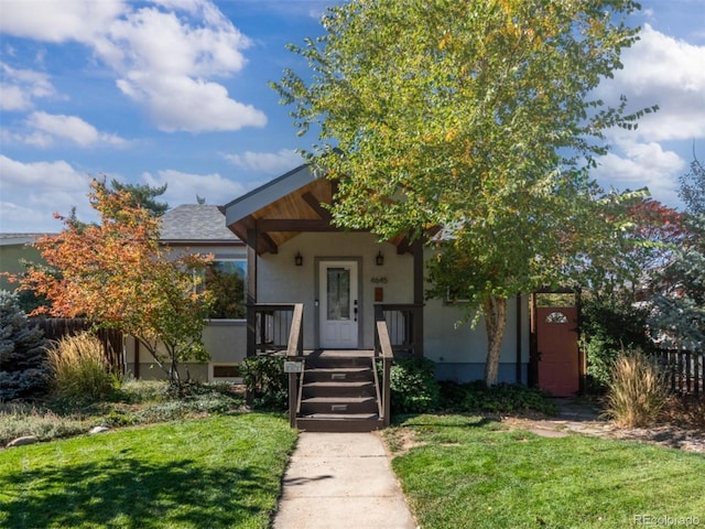 view of front of property featuring a front yard and stucco siding