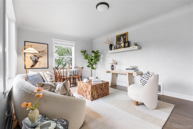 sitting room featuring baseboards and wood finished floors