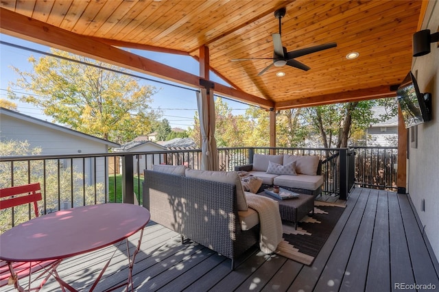 wooden terrace featuring outdoor lounge area and a ceiling fan