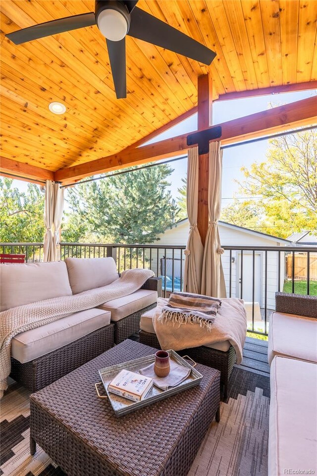 wooden terrace with an outdoor hangout area