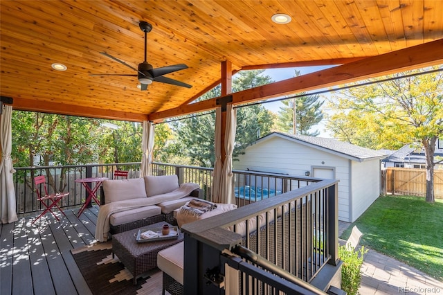 deck featuring a yard, fence, outdoor lounge area, and a ceiling fan