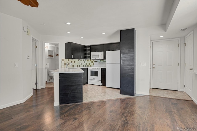5250 S Huron Way Unit 3-205, Littleton, CO 80120 - kitchen featuring white appliances, dark cabinets, light countertops, baseboards, and recessed lighting
