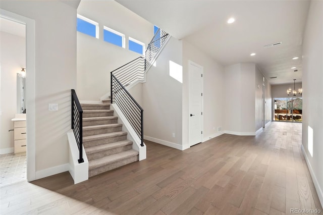 foyer entrance featuring hardwood / wood-style flooring and an inviting chandelier