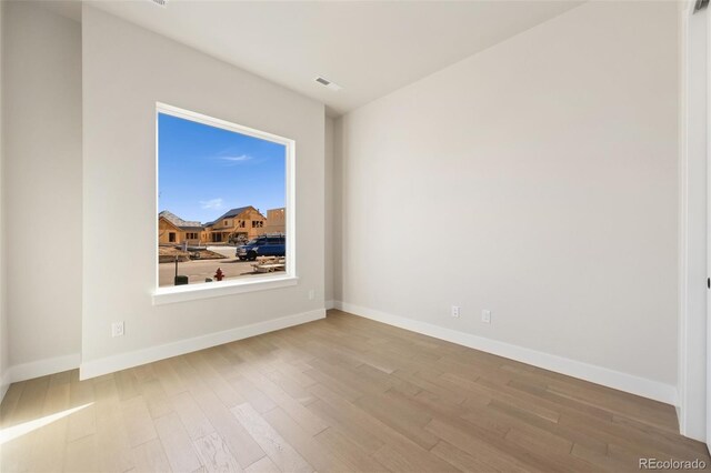 1724 Barefoot Dr, Windsor, CO 80550 - spare room featuring wood finished floors and baseboards