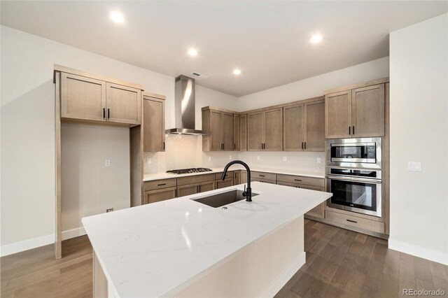 1724 Barefoot Dr, Windsor, CO 80550 - kitchen featuring stainless steel appliances, a sink, wall chimney range hood, dark wood finished floors, and recessed lighting